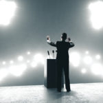 Businessman,giving,speech,in,backlit,audience ,business,and,leader,concept
