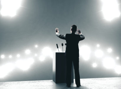 Businessman,giving,speech,in,backlit,audience ,business,and,leader,concept