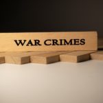 War,crimes,written,on,wooden,surface ,law,and,state