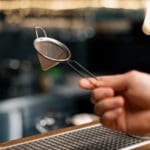 Bartender's,tool,for,making,cocktails,bartender,holds,strainer,in,his