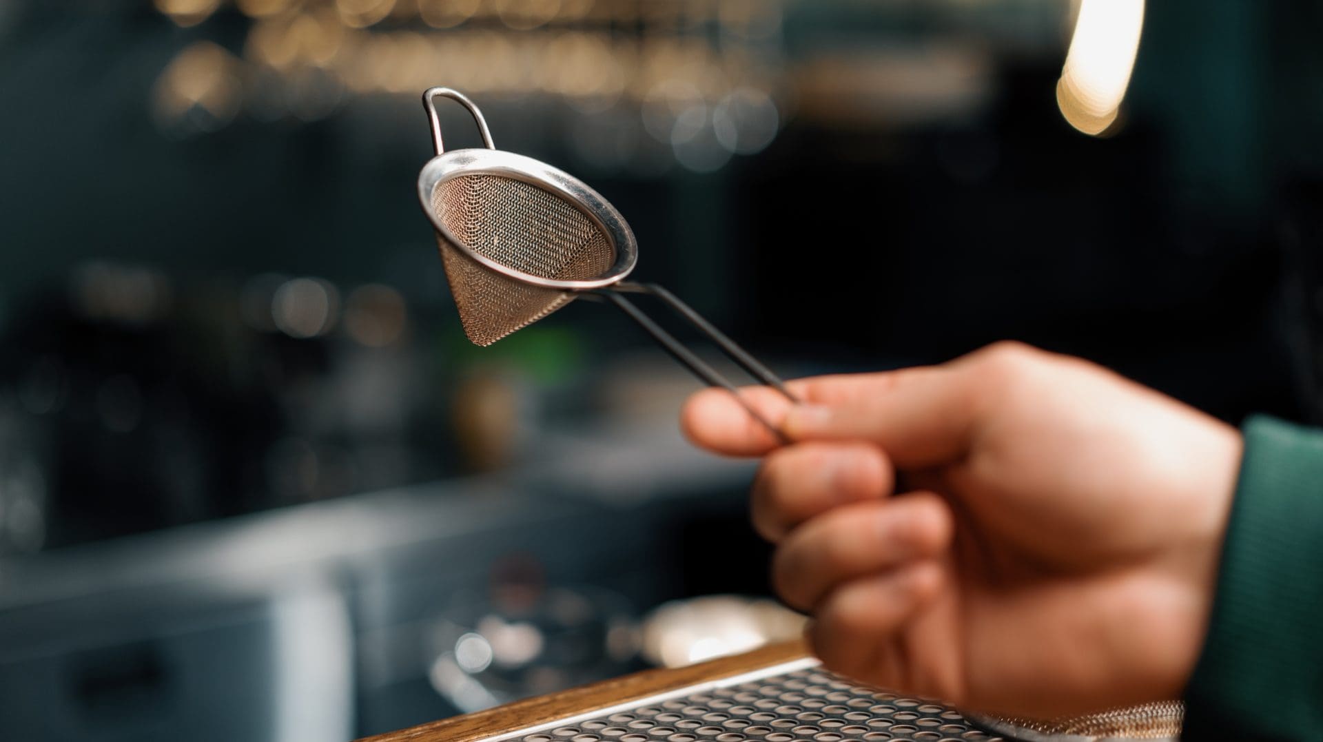 Bartender's,tool,for,making,cocktails,bartender,holds,strainer,in,his