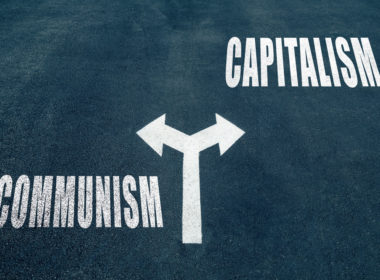 Communism,vs,capitalism,choice,concept,,two,direction,arrows,on,asphalt