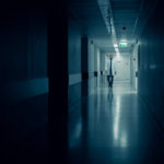 Medical,doctor,walks,into,dark,part,of,the,hospital,corridor