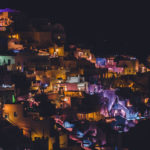 A,colorful,night,city,lights,of,a,houses,in,thira