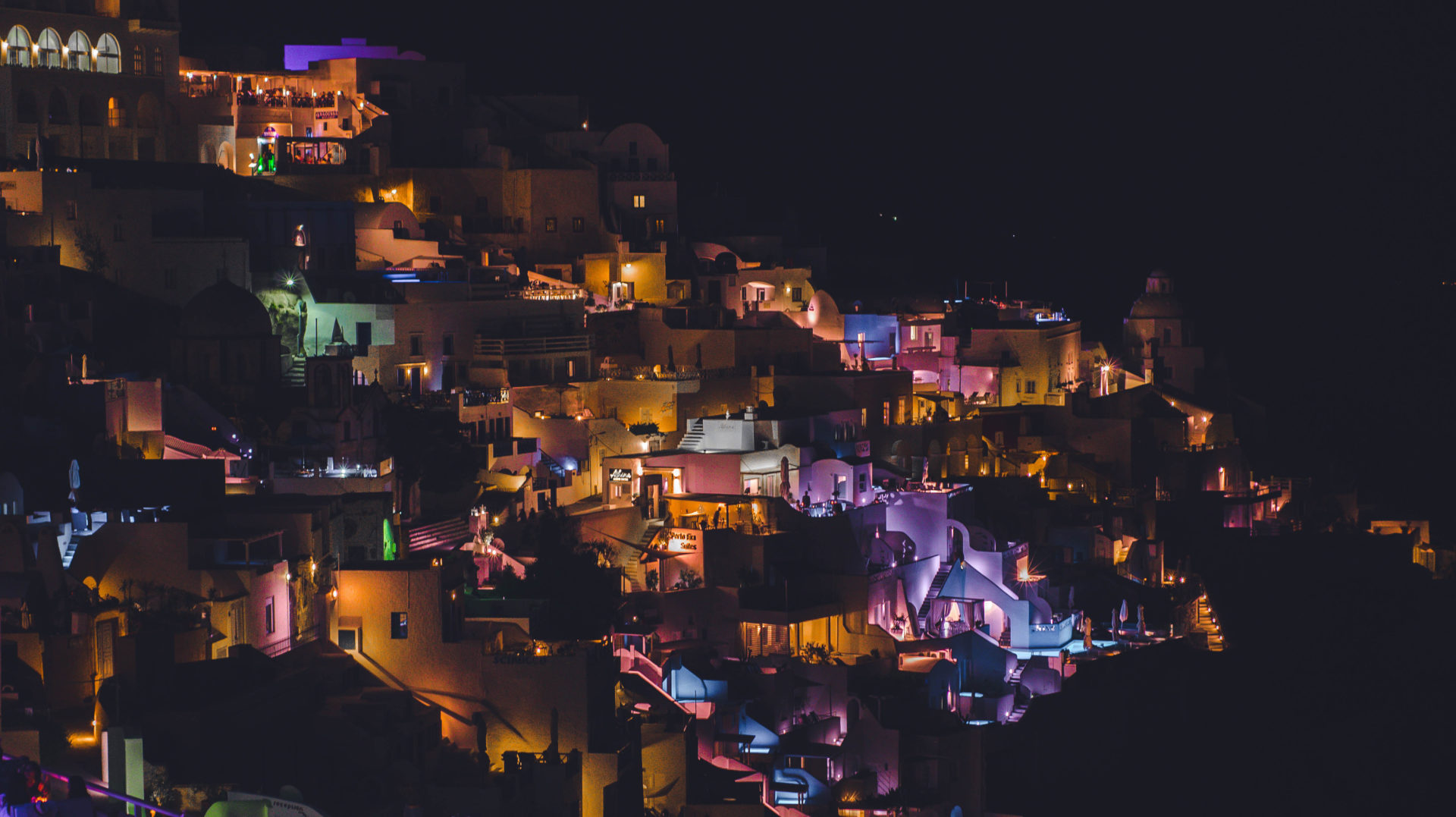 A,colorful,night,city,lights,of,a,houses,in,thira