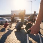 Group,of,people,walking,to,airport,terminal,at,summer,sunset