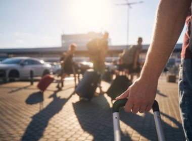 Group,of,people,walking,to,airport,terminal,at,summer,sunset