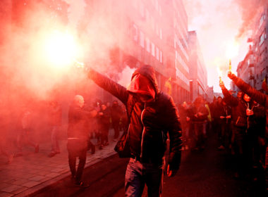 Protesters,of,right wing,and,far right,flemish,associations,light,up,flares