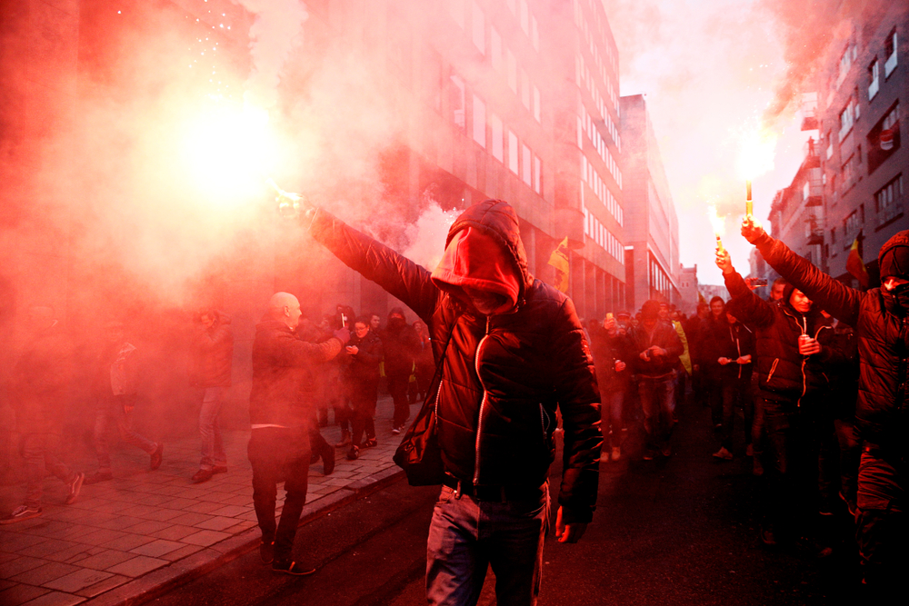 Protesters,of,right wing,and,far right,flemish,associations,light,up,flares