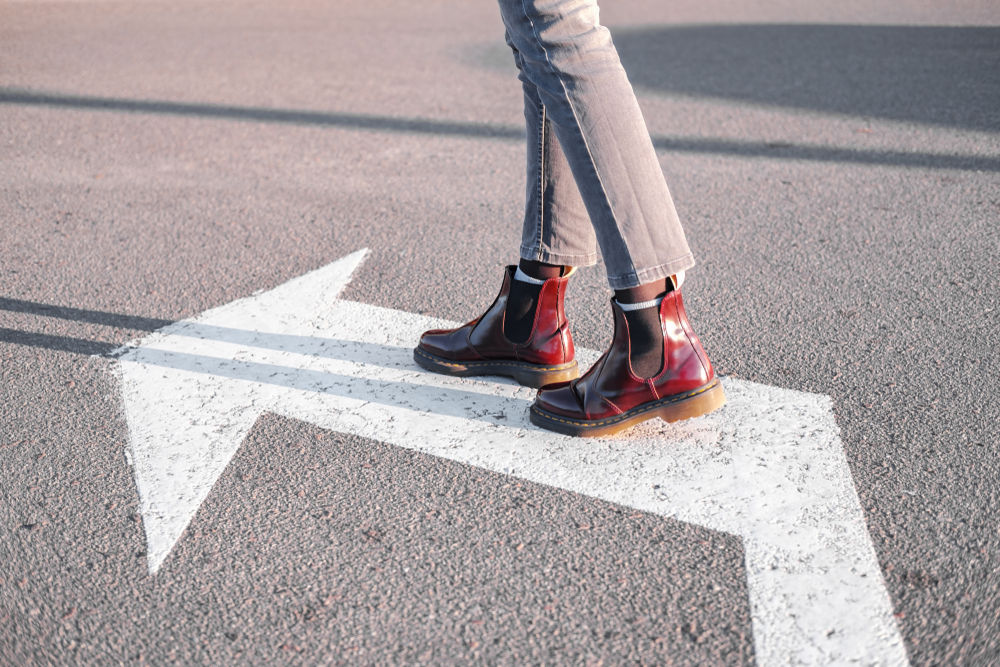 Feet,walking,along,the,left,turn,sign ,concept,of,making