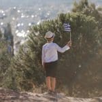 Smiling,baby,toddler,,boy,holding,a,greece,flag,on,city