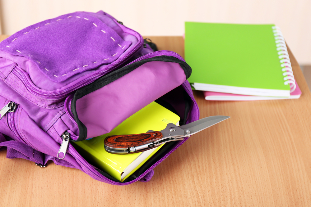 Backpack,with,knife,in,classroom,,close,up ,juvenile,delinquency