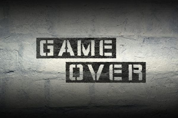 Game,over,stencil,print,on,the,grunge,white,brick,wall