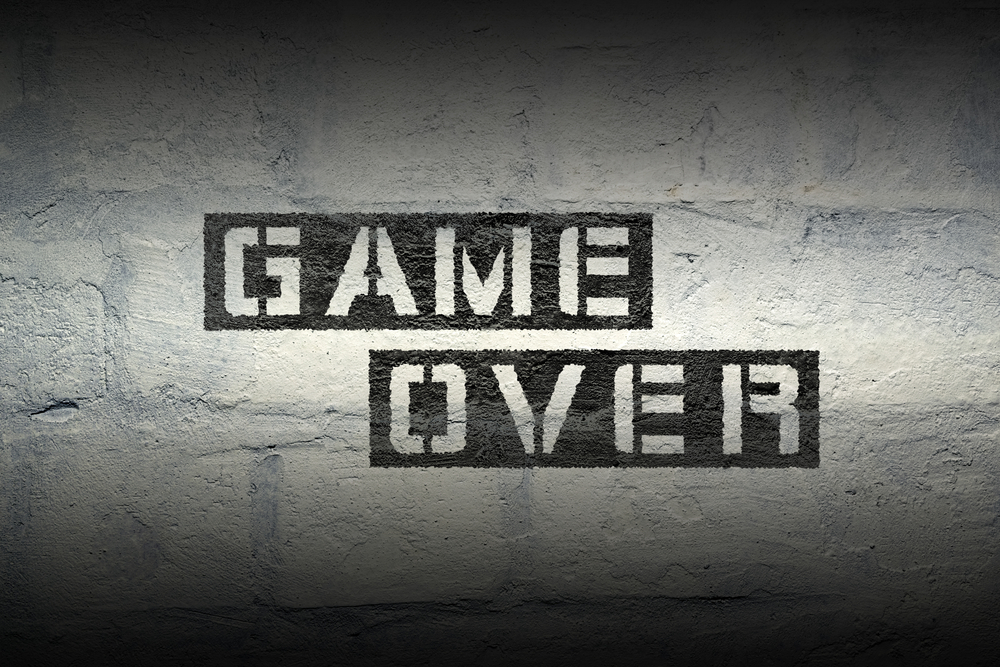 Game,over,stencil,print,on,the,grunge,white,brick,wall