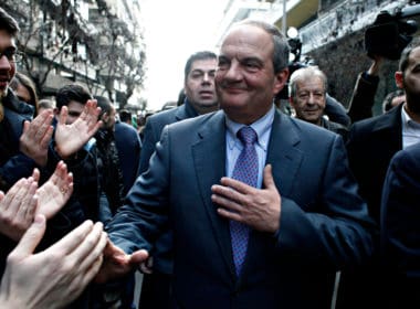 Former,prime,minister,costas,karamanlis,greets,supporters,outside,offices,of