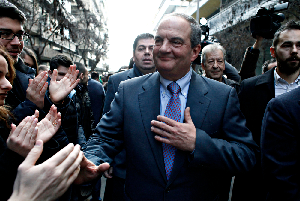 Former,prime,minister,costas,karamanlis,greets,supporters,outside,offices,of