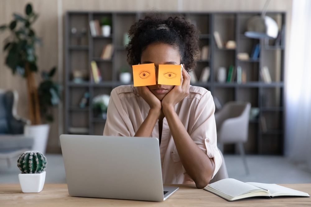 Tired,afro,american,millennial,student,girl,sleeping,at,workplace,with