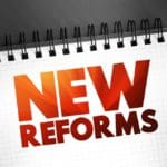 New,reforms,text,quote,on,notepad,,concept,background