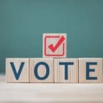 A,wooden,block,with,the,letters,vote,and,a,check