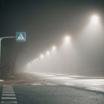 Foggy,night,scene,with,an,illuminated,pedestrian,crossing,and,a