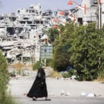 Homs,,syria,,september,2013,a,woman,walks,near,a,residential