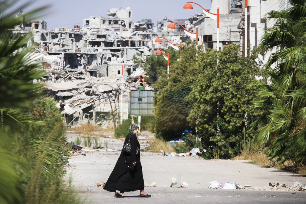 Homs,,syria,,september,2013,a,woman,walks,near,a,residential
