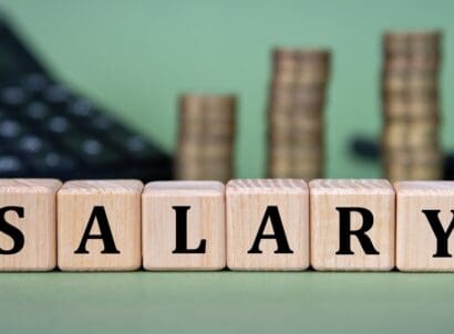 Salary, ,word,on,wooden,cubes,with,calculator,and,coins