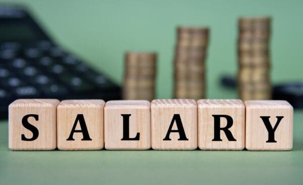 Salary, ,word,on,wooden,cubes,with,calculator,and,coins