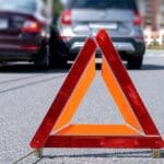 Warning,triangle,placed,on,road,after,vehicle,accident,in,urban