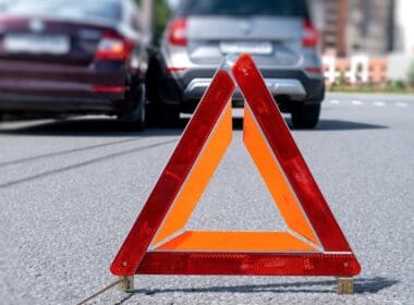 Warning,triangle,placed,on,road,after,vehicle,accident,in,urban