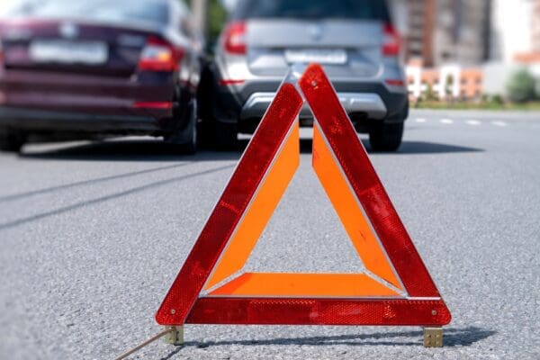 Warning,triangle,placed,on,road,after,vehicle,accident,in,urban