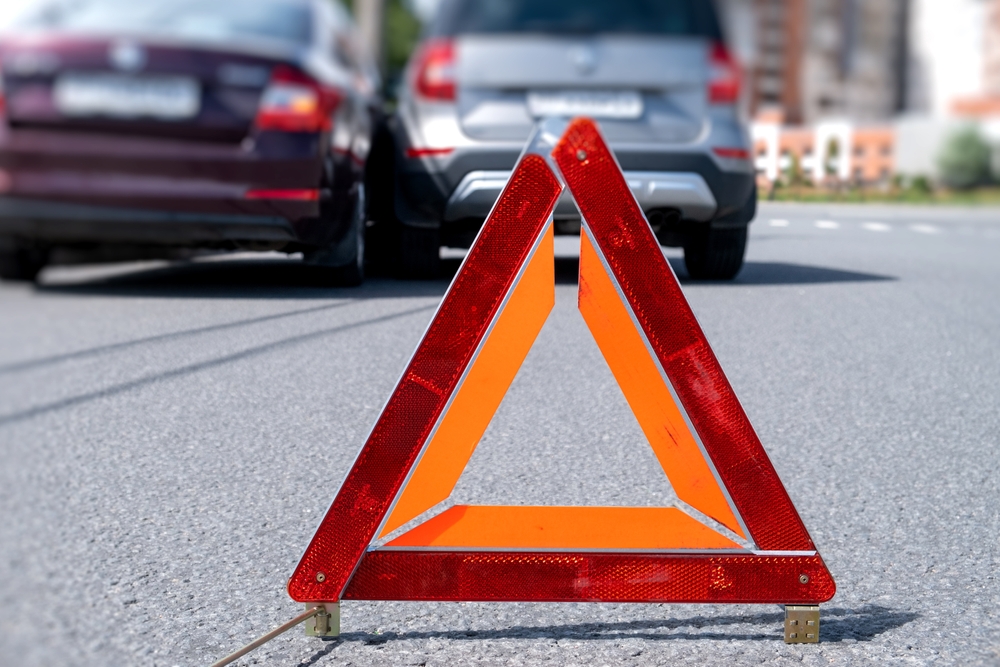 Warning,triangle,placed,on,road,after,vehicle,accident,in,urban