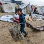 Displaced,palestinians,inspect,their,tents,after,they,were,hit,by
