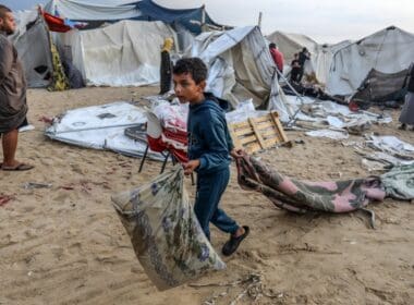 Displaced,palestinians,inspect,their,tents,after,they,were,hit,by