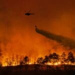 Fire,fighting,helicopter,carry,water,bucket,to,extinguish,the,forest