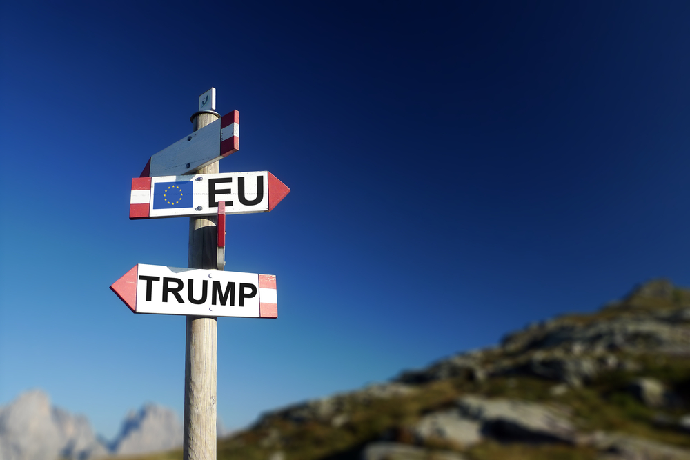 Trump,and,european,flag,in,two,directions,on,road,sign