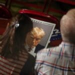 Donald,trump,supporters,hold,a,poster,with,a,photo,of