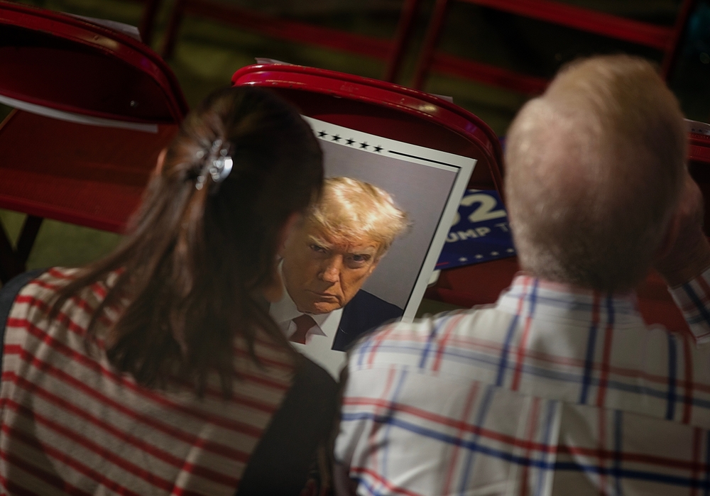 Donald,trump,supporters,hold,a,poster,with,a,photo,of