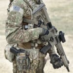 Soldier,with,assault,rifle,and,flag,of,greece,on,military