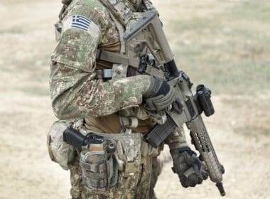 Soldier,with,assault,rifle,and,flag,of,greece,on,military