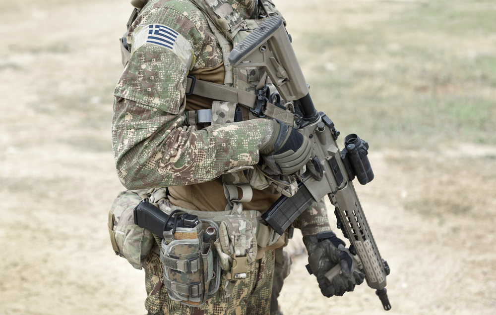 Soldier,with,assault,rifle,and,flag,of,greece,on,military