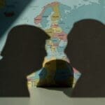 Donald,trump,and,vladimir,putin,silhouettes,over,world,political,map