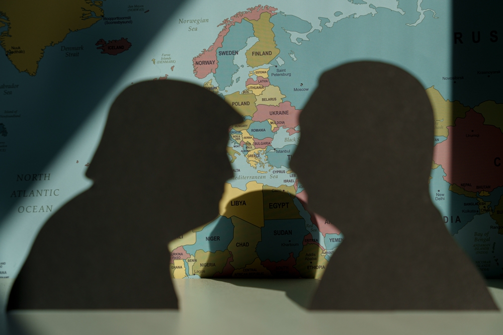 Donald,trump,and,vladimir,putin,silhouettes,over,world,political,map
