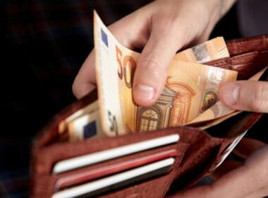 Man,handing,wallet,with,euro