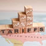 Wooden,blocks,spelling,tariffs,are,placed,on,a,map,of