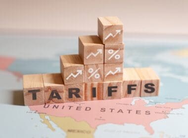 Wooden,blocks,spelling,tariffs,are,placed,on,a,map,of