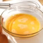 Whisking,eggs ,whipped,raw,eggs,in,a,bowl,with,whisk