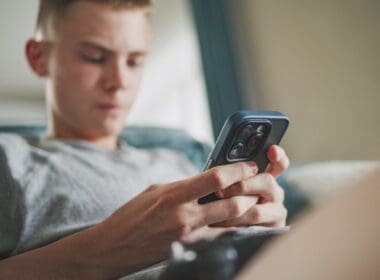 Caucasian,teenager,chats,in,messaging,app,with,friends,or,watches