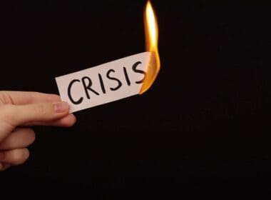 Burning,a,piece,of,paper,with,the,word,"crisis",written