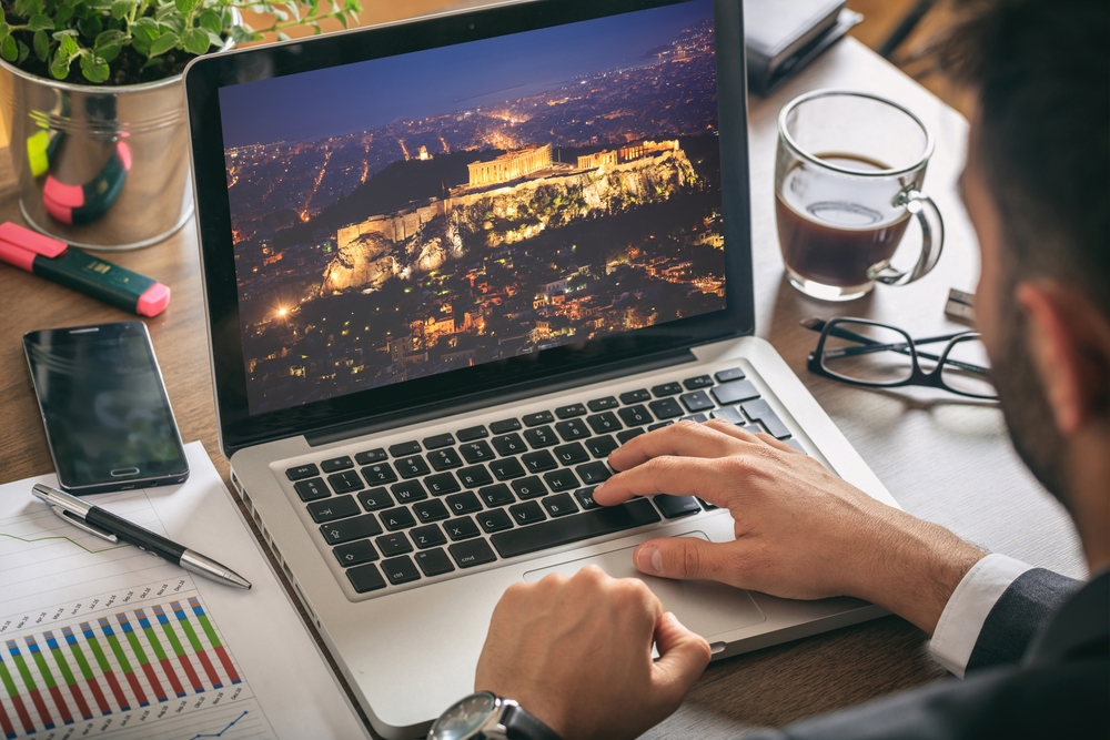 Travel,to,greece,concept ,man,planning,vacations,,sitting,in,his